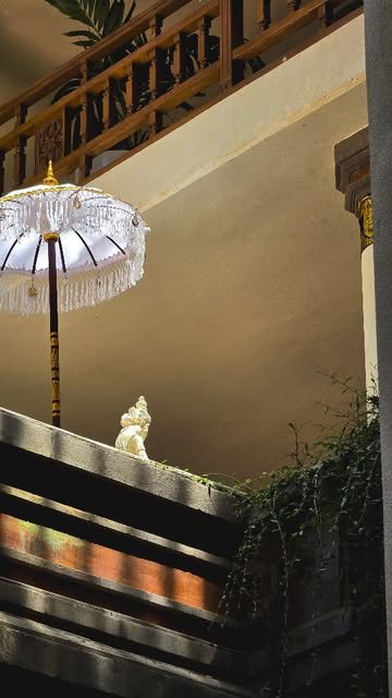 A white ceremonial umbrella in a Balinese temple doorway